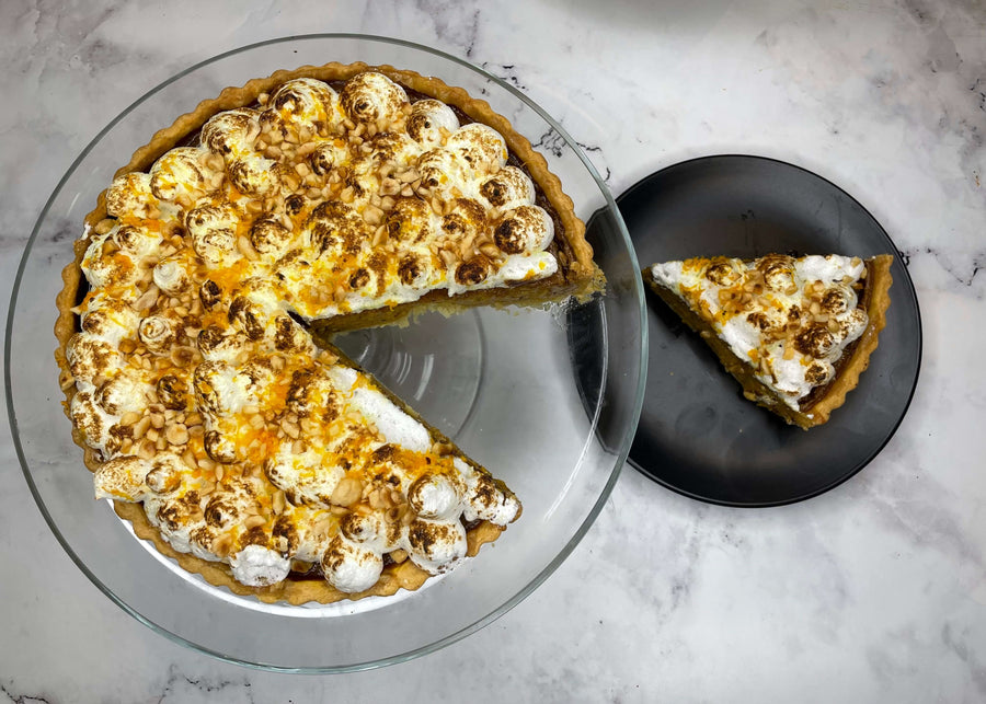 Pumpkin meringue pie with roasted hazelnuts and orange zest